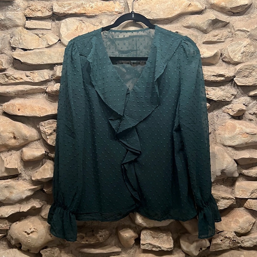 Bell sleeves. No stretch. Ruffle front detail. Sheer back.
